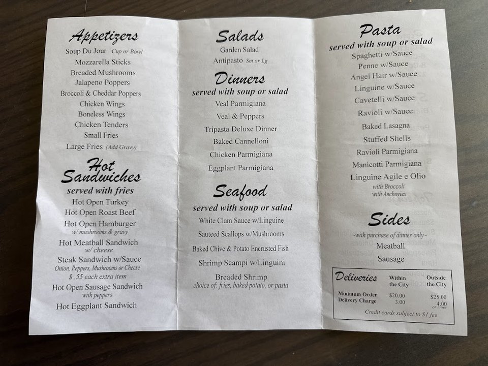 Printed menu with Italian dinners and seafood plates.